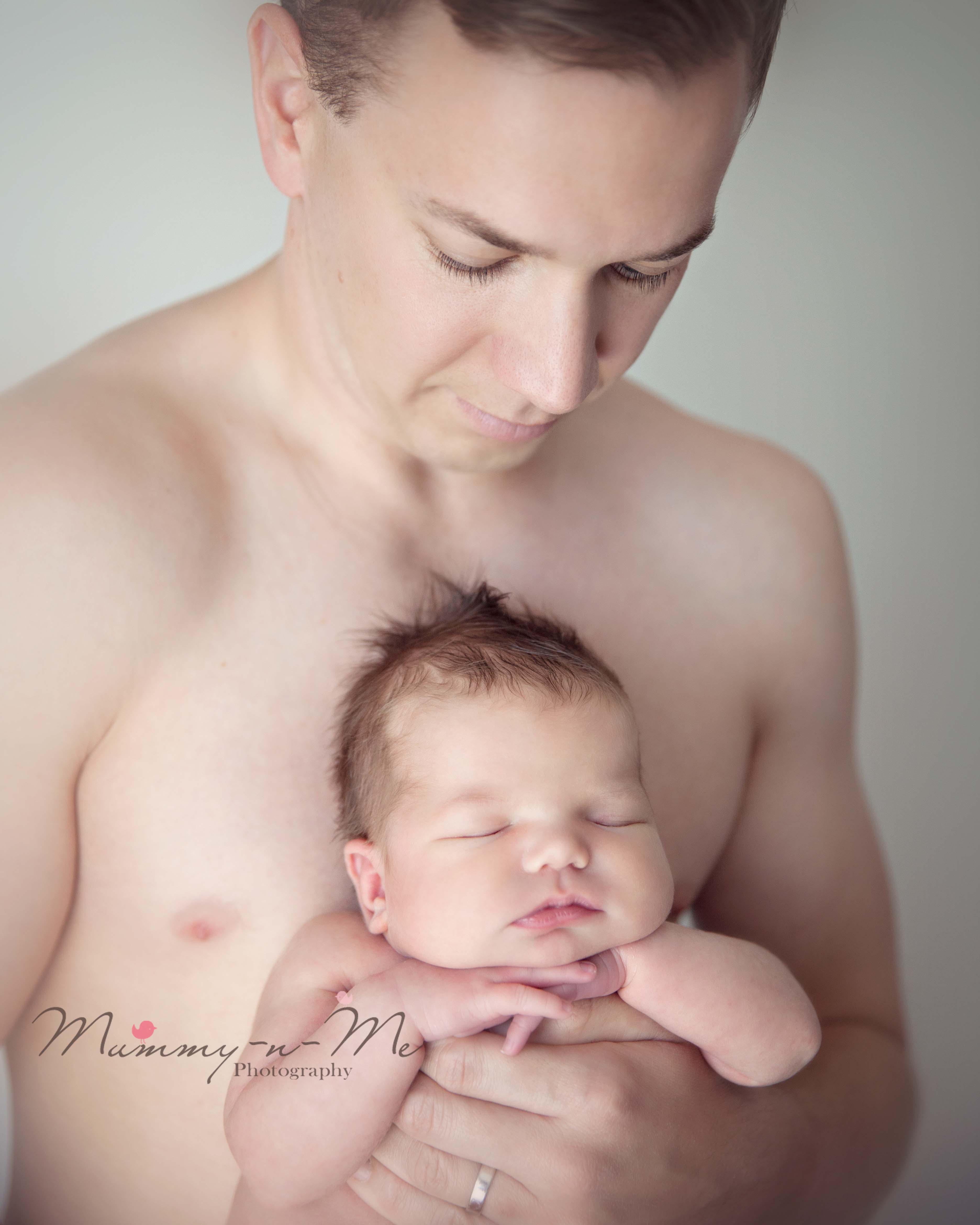 newborn girl in daddys hands Brisbane Newborn family Photographer