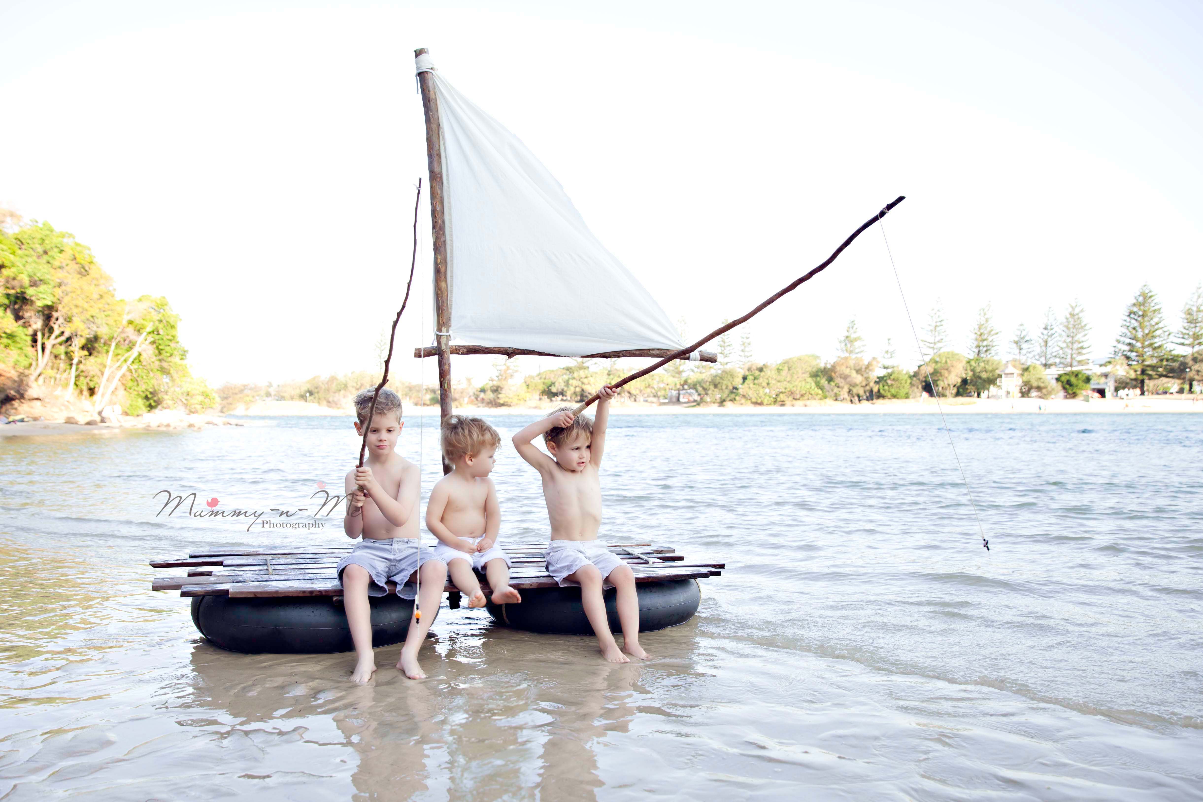boys on raft with fishing rods at beach gold coat beach photographer