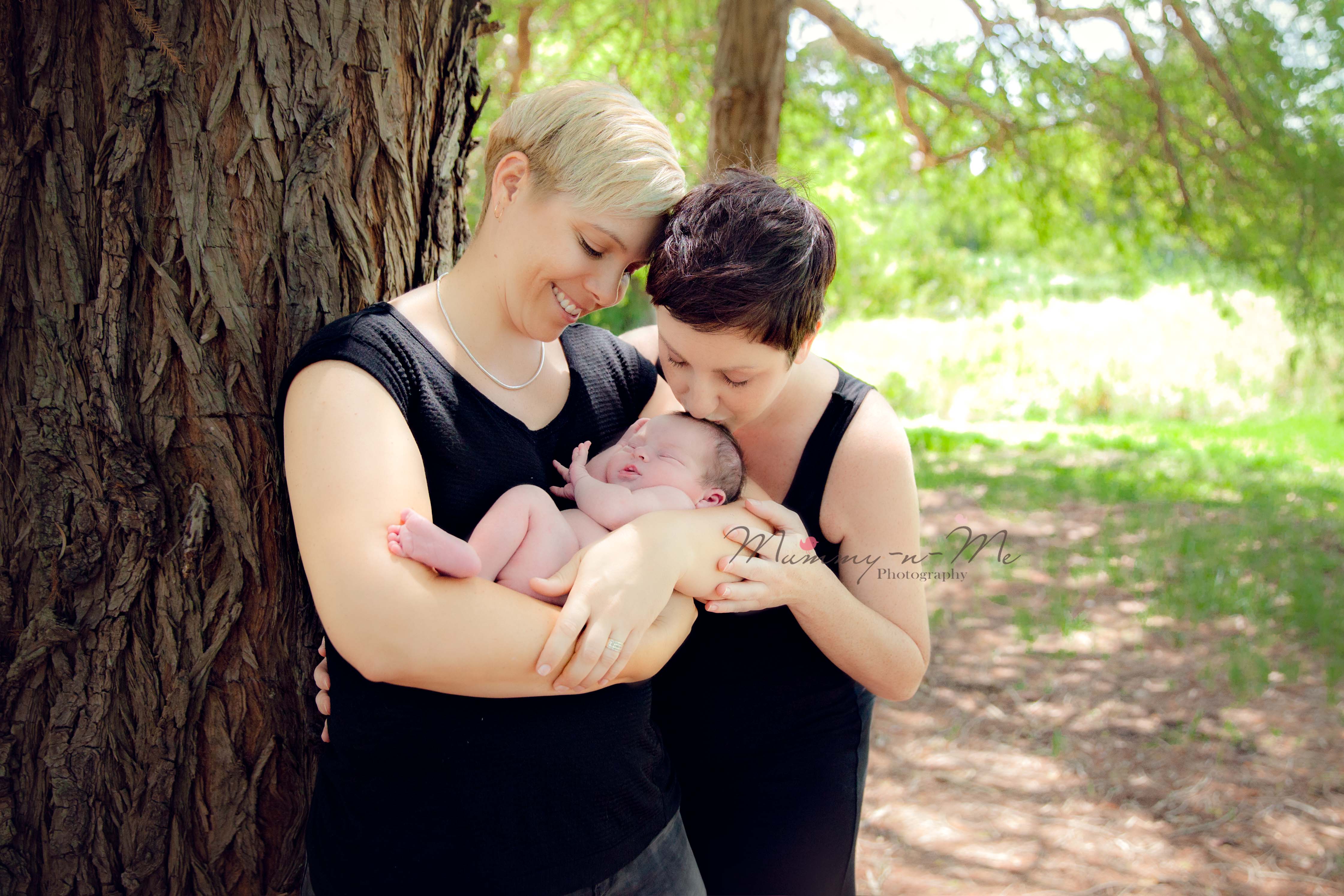 lesbian couple with newborn in park brisbane newborn photographer