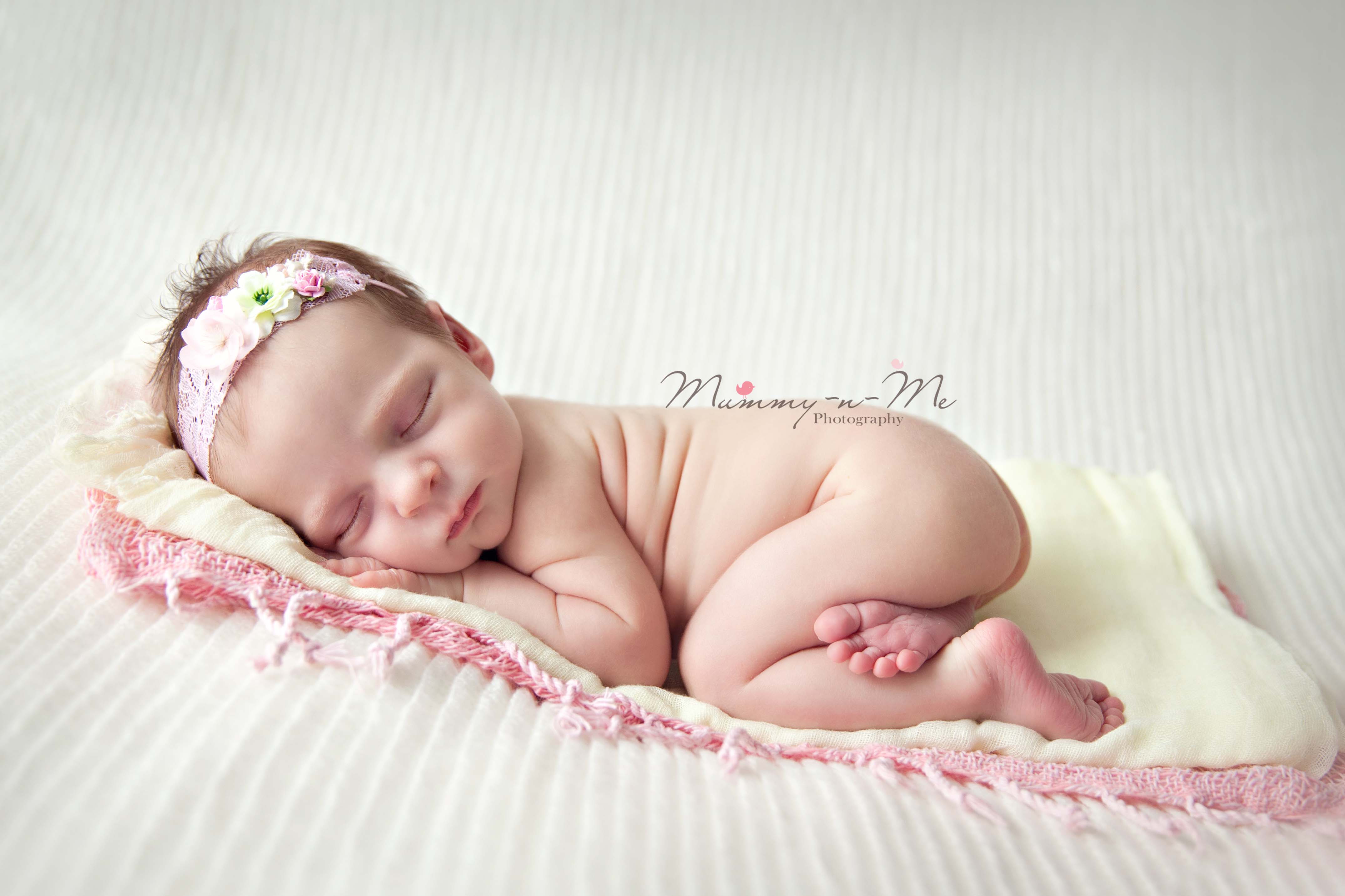 newborn girl in pink and yellow brisbane newborn photographer
