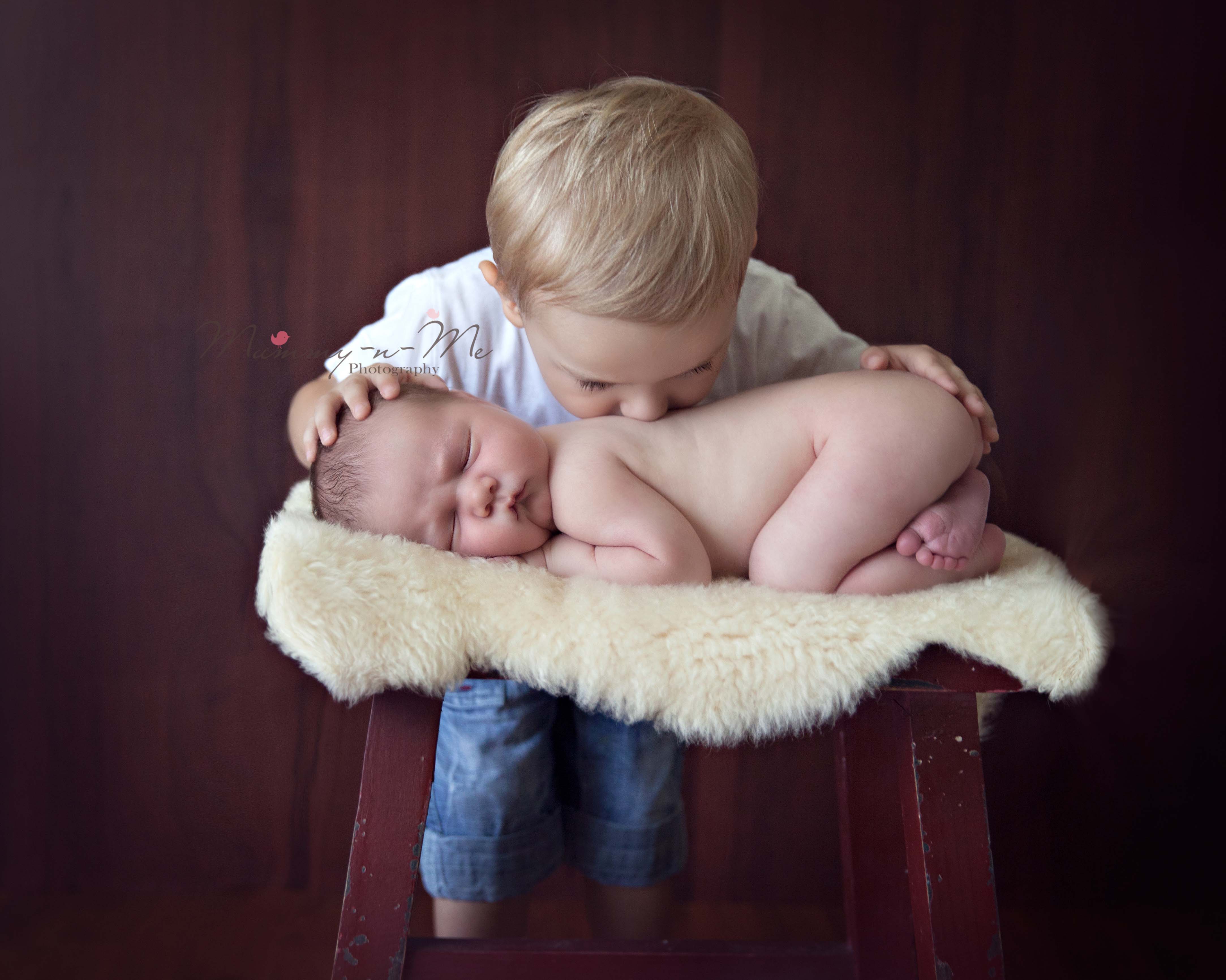 Newborn Boy getting kisses from big brother Brisbane Newborn Photographer