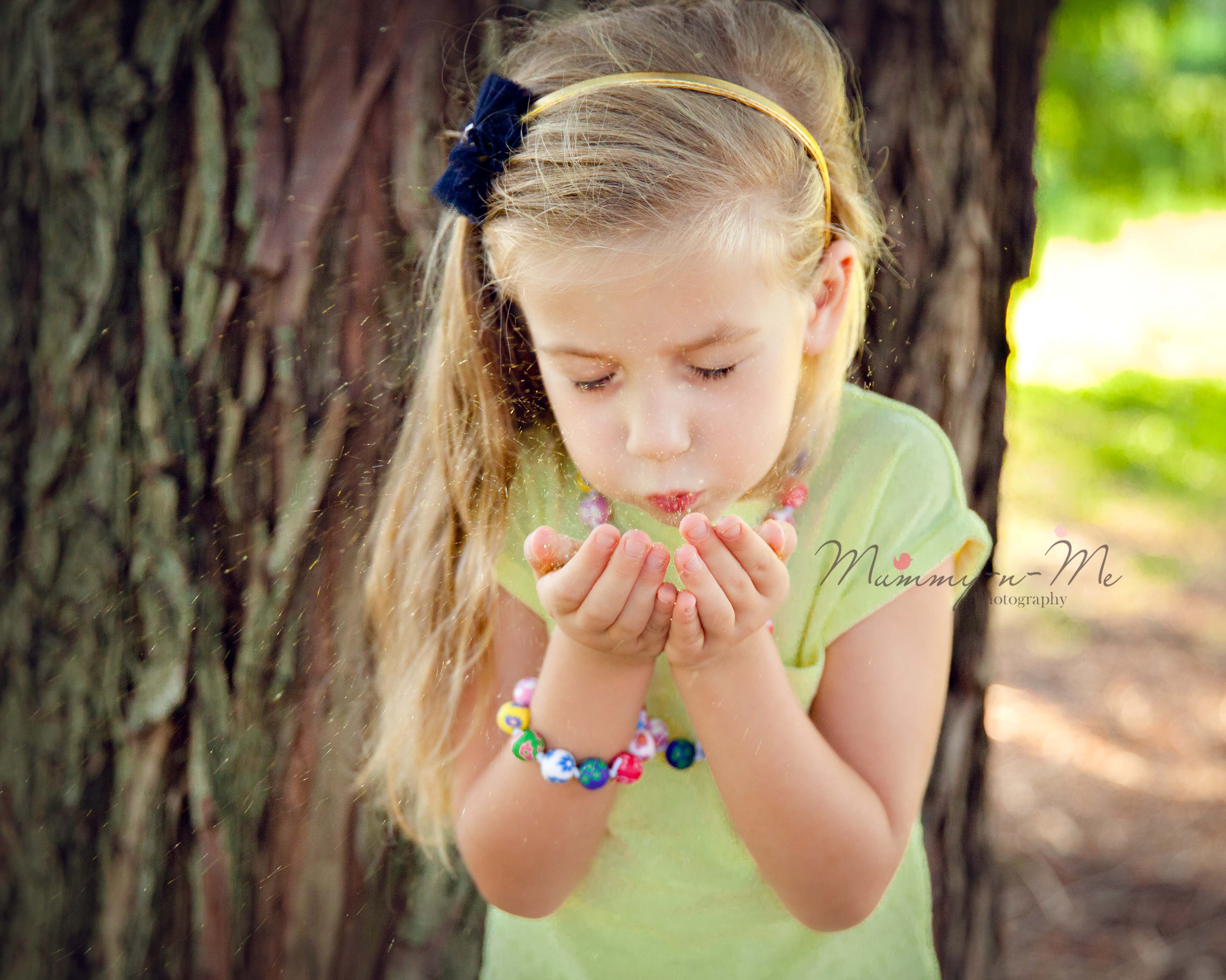 Family park session beautiful girl blowing glitter Brisbane Family Child Photographer