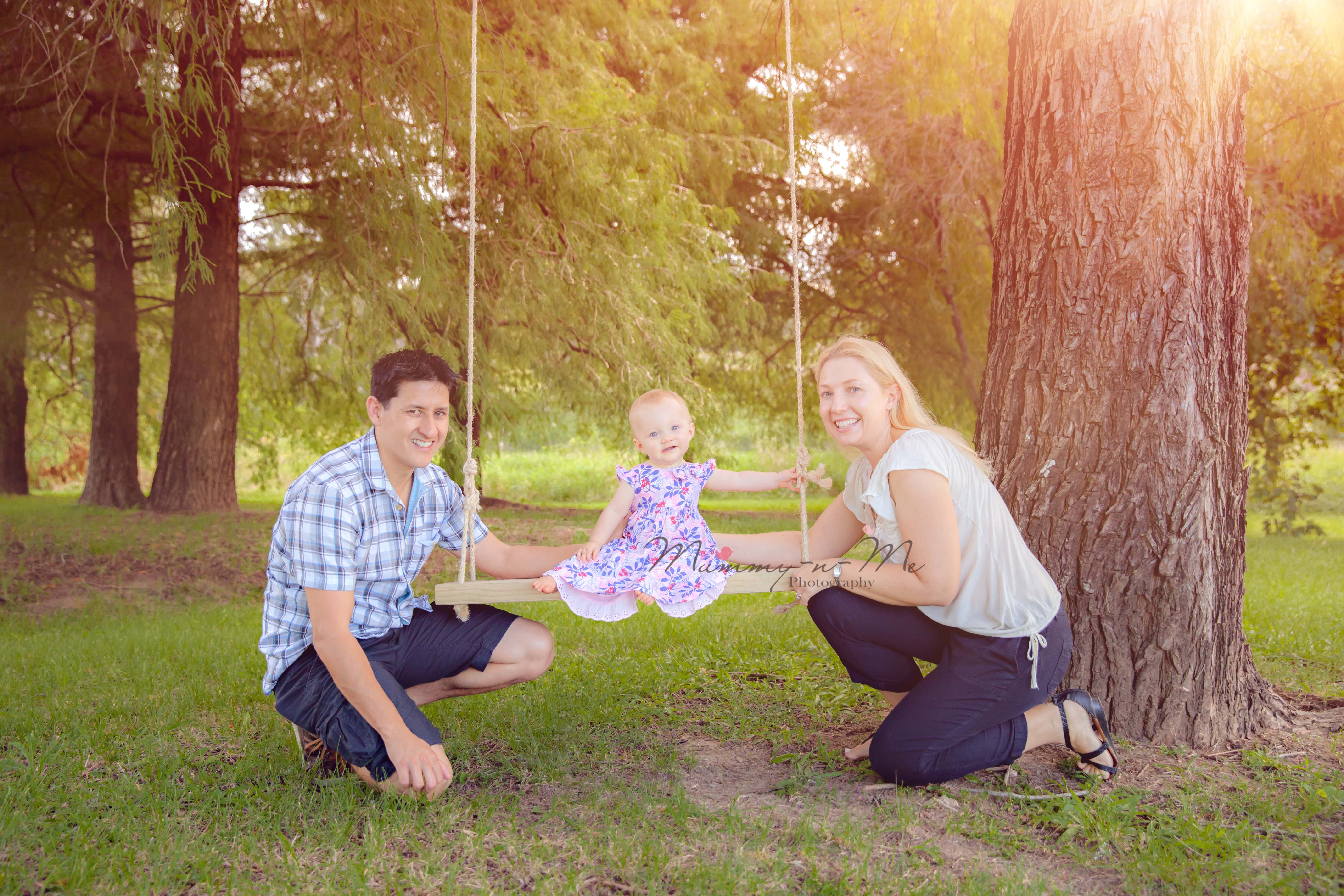 baby girl with family in park on swing Brisbane Family Child Baby Photographr