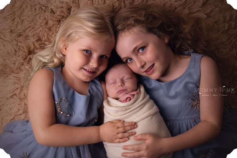 newborn boy with sisters
