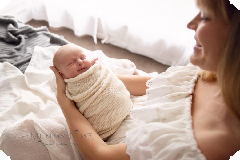 newborn boy with mum on bed in brisbane