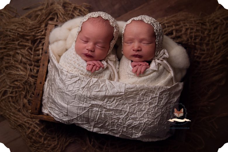 newborn twin girls in vintage bonnets