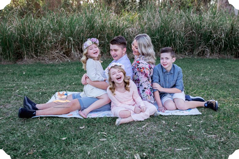 family laughing at the park 